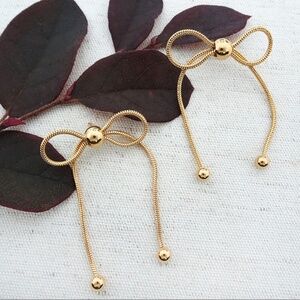 Catherine Popesco large gold bow earrings with dangles, NWT